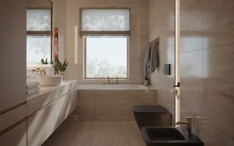 Elegancka łazienka z oknem na wprost drzwi, wanna, czarna miska WC i bidet, kamienne płytki, złote baterie.