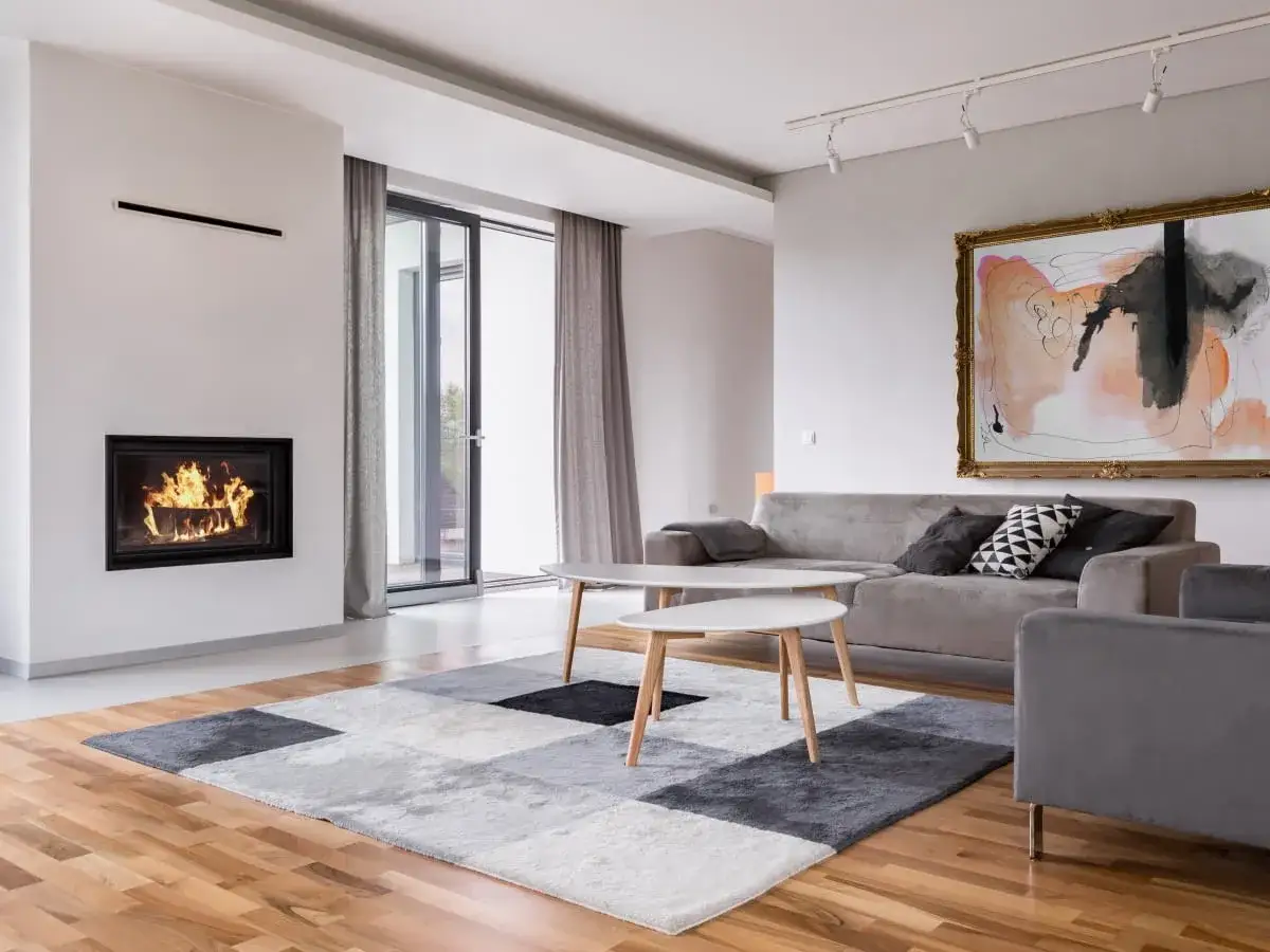 Nowoczesny salon z kominkiem i sofą, idealny do stworzenia harmonii w stylu feng shui.