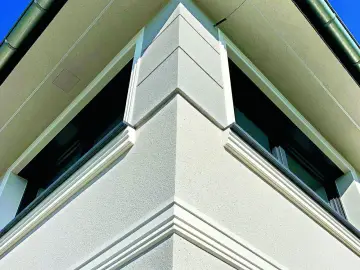 Elegancki gzyms co to? Detal architektoniczny zdobiący narożnik budynku, podkreślający jego nowoczesny styl.
